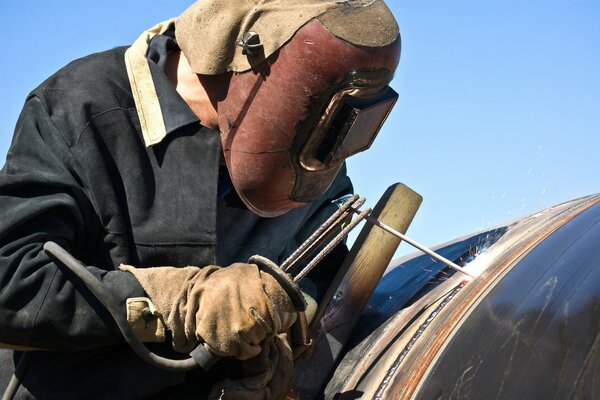 Welder wearing a helmet while working