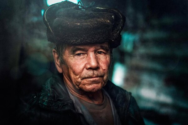 An elderly man in a hat in the village