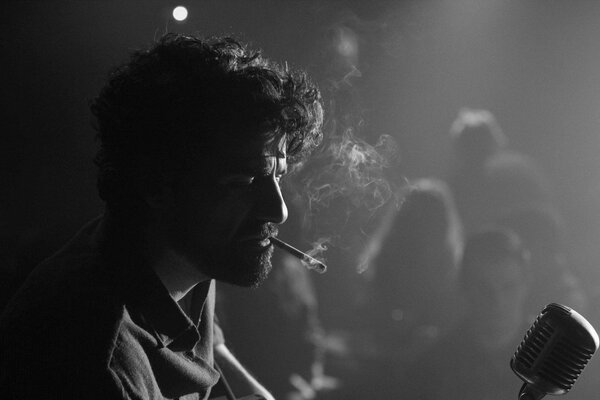 Smoking musician at the microphone in b/w color