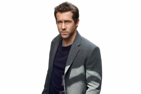 Ryan Reynolds at a photo shoot in a gray jacket