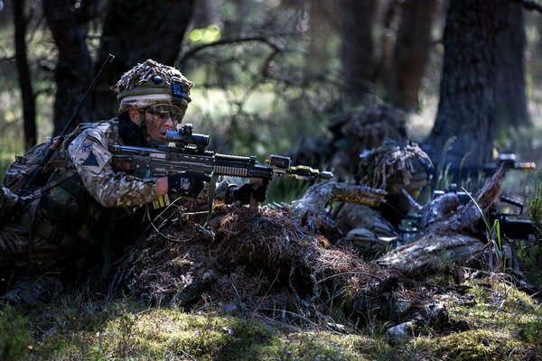 Soldiers are sitting in ambush with weapons