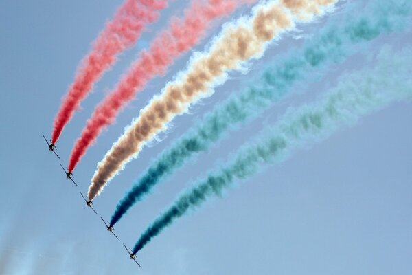 A bright show in the sky, a color plume is sprayed next to a slender one