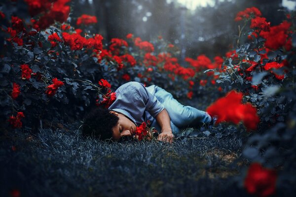 A man is lying on a background of flowers