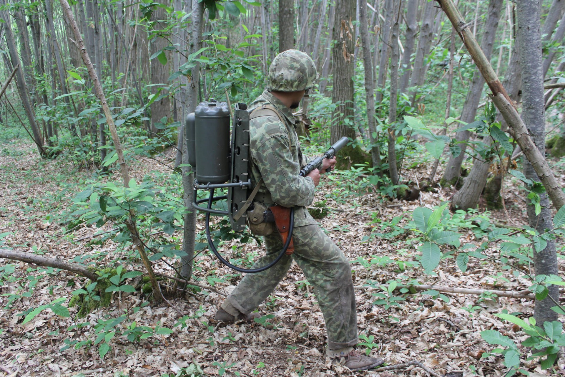 men industrial complex flamethrower forest