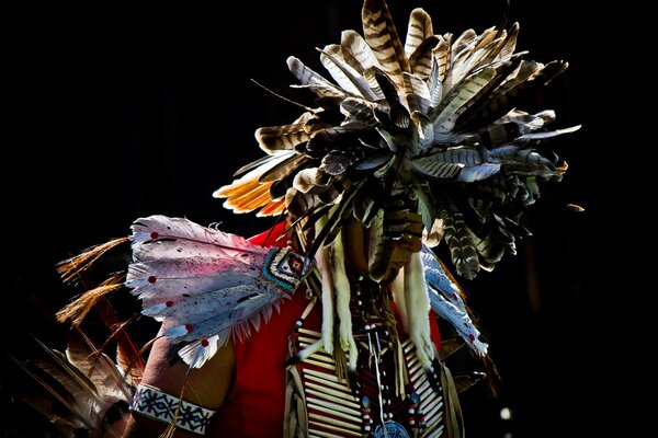 Indian in feathers on a black background