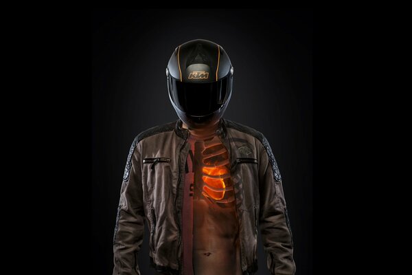 A motorcyclist in a helmet, with a bare heart