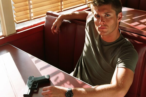 Jensen Eccles mit einer Pistole. Dean Winchester