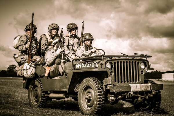 Des soldats armés montent dans une Jeep