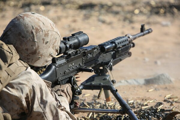 A soldier fires an m240b machine gun