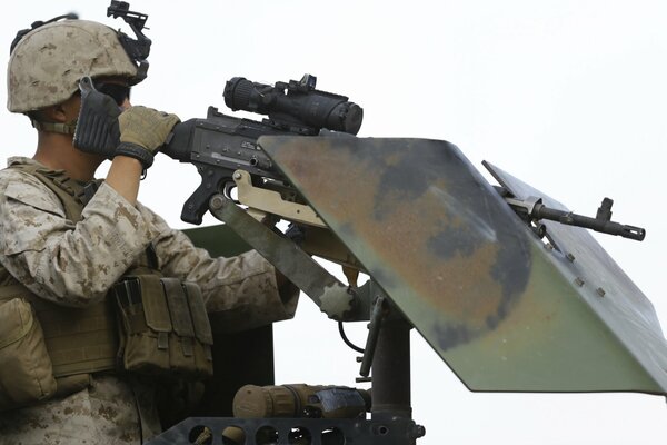 A soldier soldier shoots a weapon