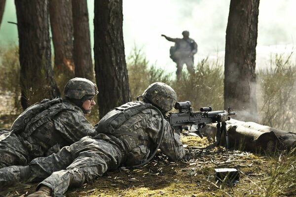 Soldiers with guns at the shooting range. An army with weapons