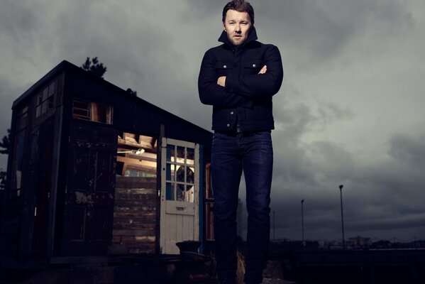 Actor Joel Edgerton on the background of the house