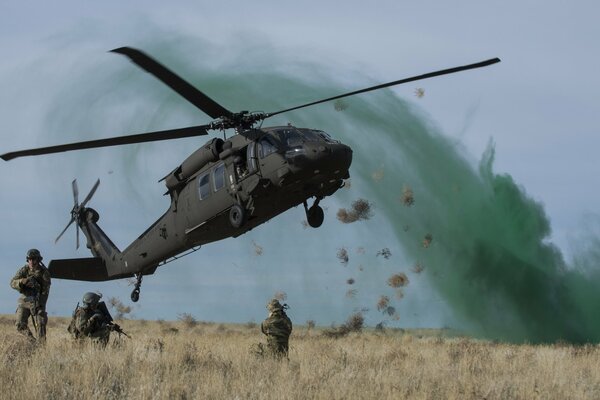 Helicopter takeoff. army soldiers on alert