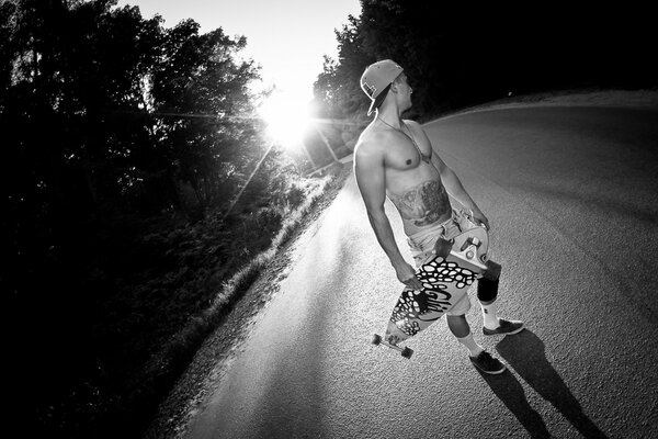 A guy with a bare torso and a longboard