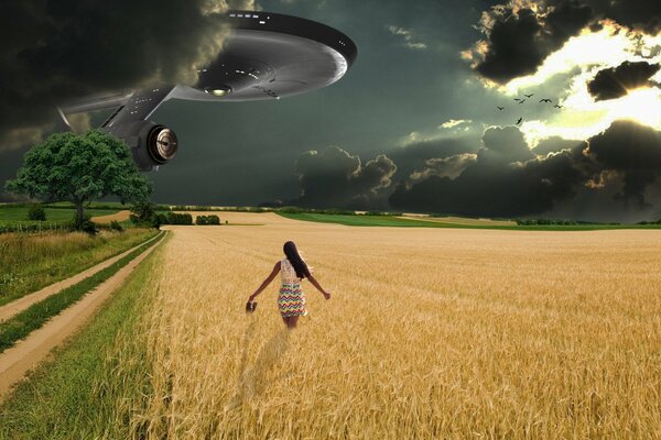 A girl in a field and an alien ship