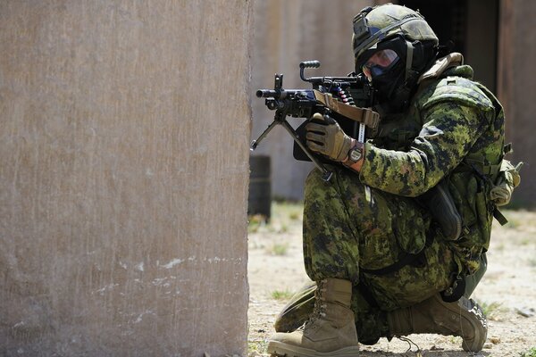 An armed man in a helmet takes aim