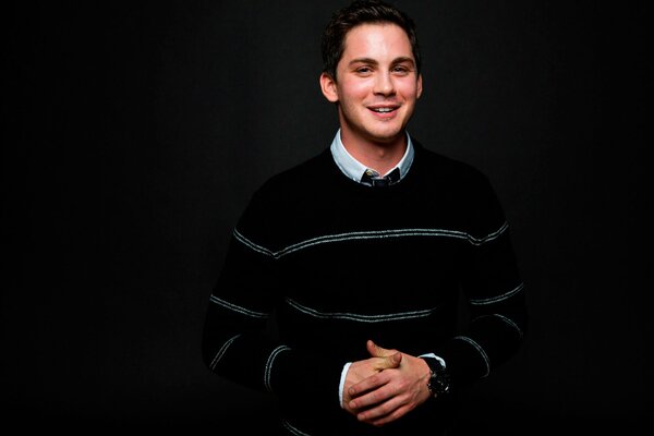 Logan Lerman smiles mysteriously at a photo shoot