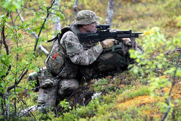 An armed soldier in an ambush