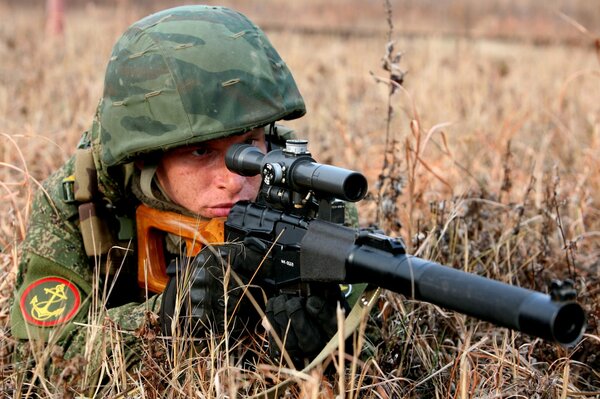 A soldier takes aim with a sniper rifle