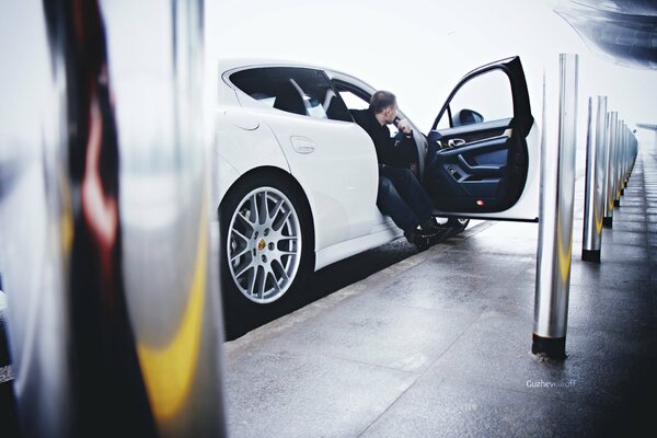 A guy in a Porsche Panamera at the airport