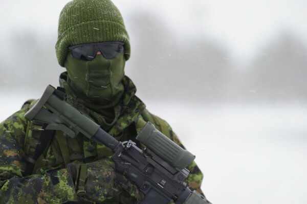 Soldier in gear with a screw on a blurry background