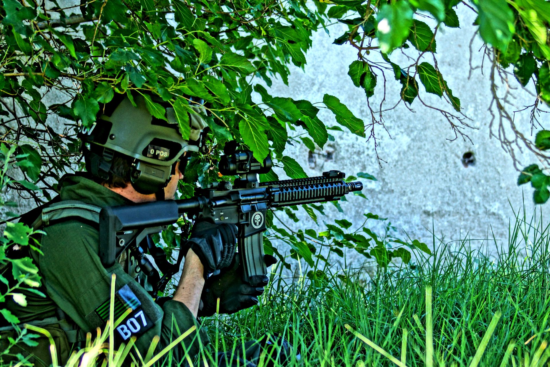 grass bush green men uniforms camouflage weapon the ready background blur