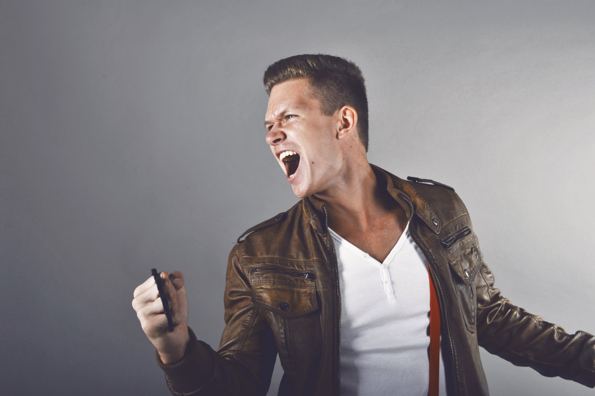 guy cry knuckles leather jacket white teeth white jersey suspenders short hair fury anger