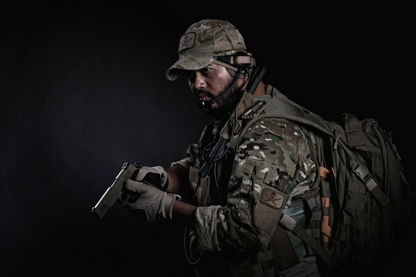 Photo de nuit d un soldat en pleine tenue et avec un sac à dos