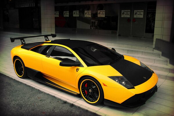 Spectacular photo of a yellow lamborghini on a beautiful building background