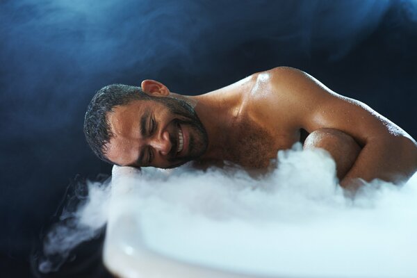 A man in a bathroom with smoke