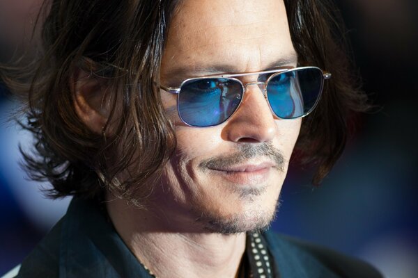 The incomparable Johnny Depp in stylish glasses and with an unstoppable grin