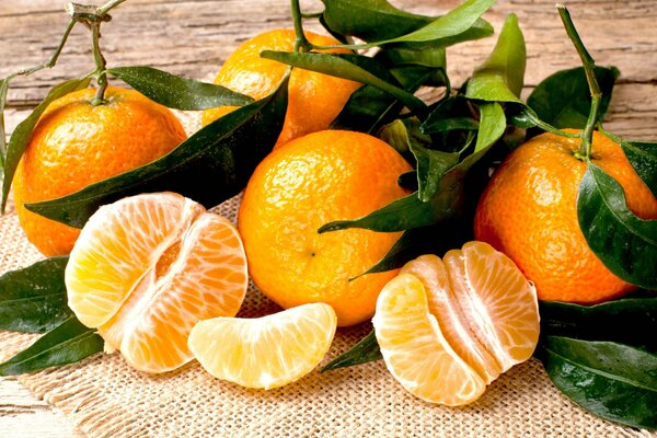 Tangerines in the peel with leaves , slices