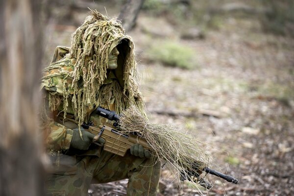 A disguised soldier in the forest on a mission