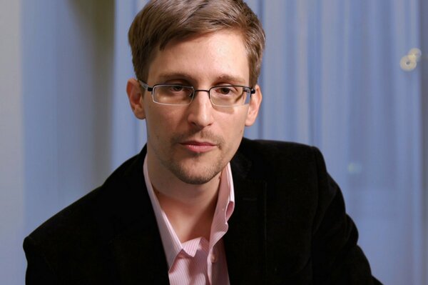 Edward Snowden with glasses looks at the camera