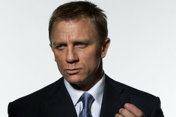 Daniel Craig in a suit with a blue tie