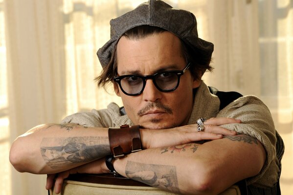 Johnny Depp in glasses and a cap