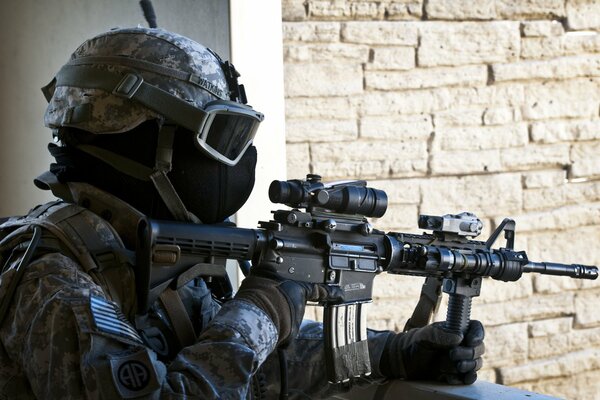 An equipped soldier in a mask and with an assault rifle