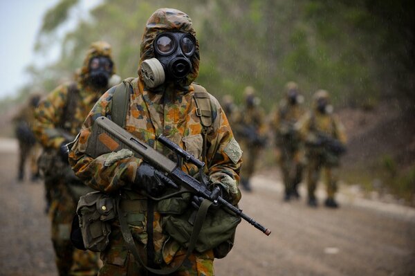 Soldiers in camouflage with automatic rifles