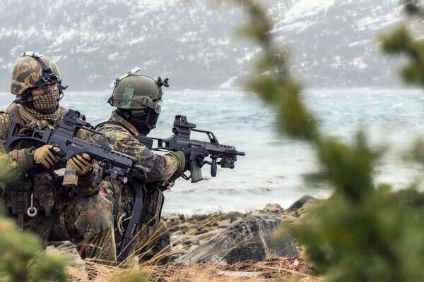 Two soldiers in equipment with rifles