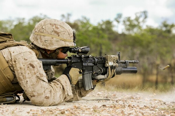 A soldier with a gun in his hands shoots