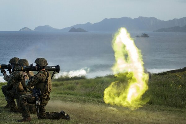 Soldiers fire weapons at the target