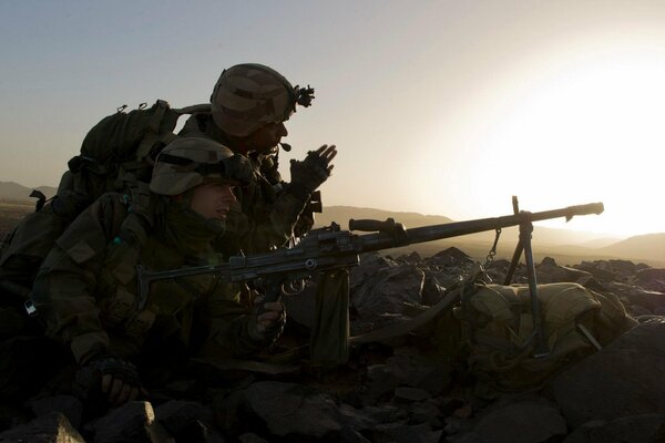 Two snipers with guns on duty