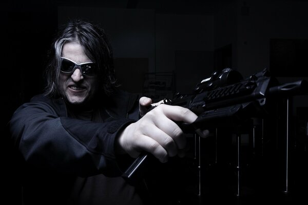 A man with a gun on a black background