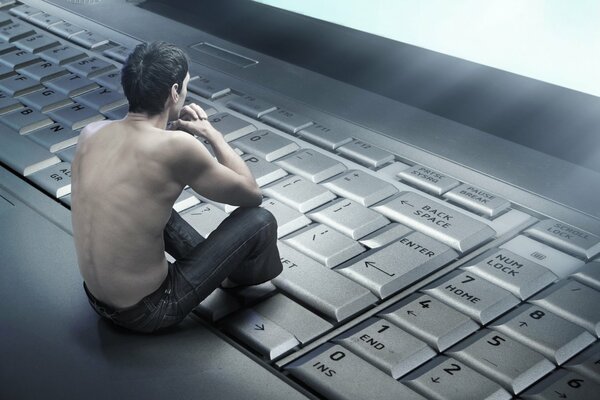 A guy with a naked torso on the keyboard