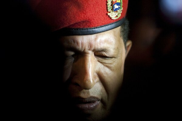 The comandante in a red beret with his eyes closed