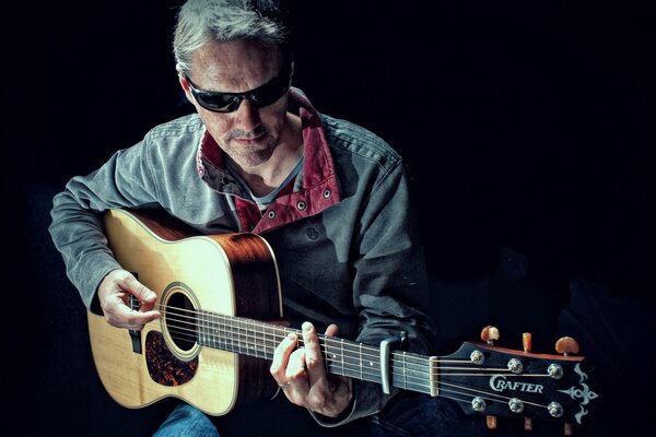 Stylish man playing guitar