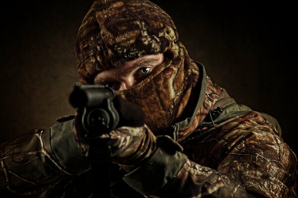 A military soldier with a gun in his hands