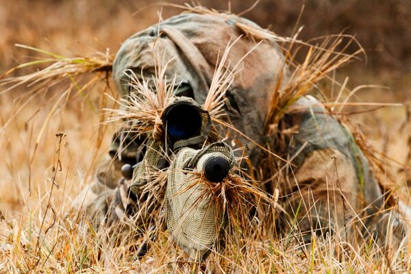 A disguised soldier with a gun