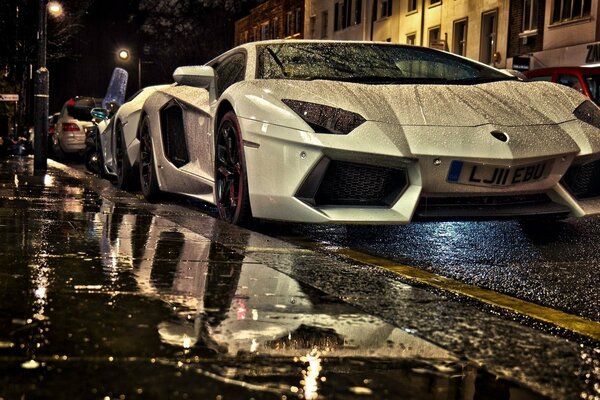 Sports cars in a rainy night city