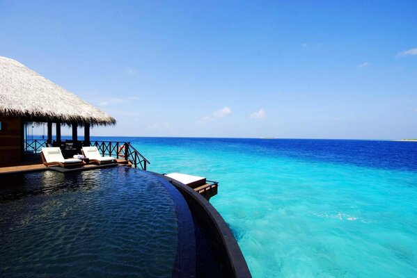 Bungalow on the shore of the blue ocean